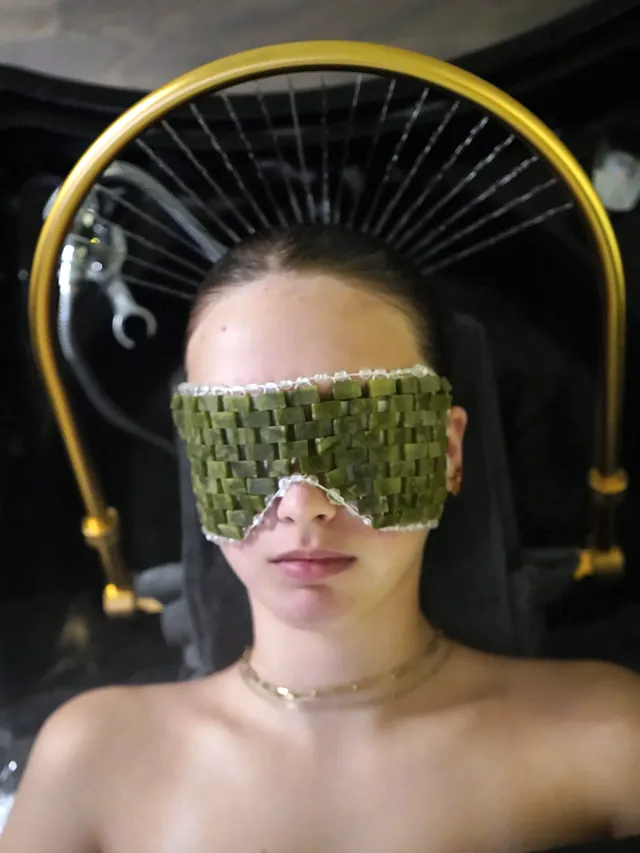 Guest resting under the gold water halo during the Japanese head spa