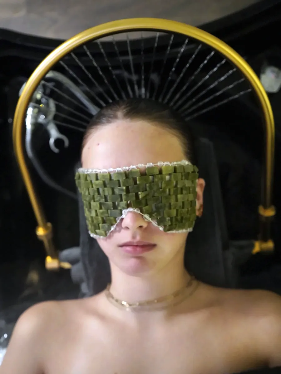 Guest resting under the gold water halo with a jade eye mask during the Japanese head spa at The Quin